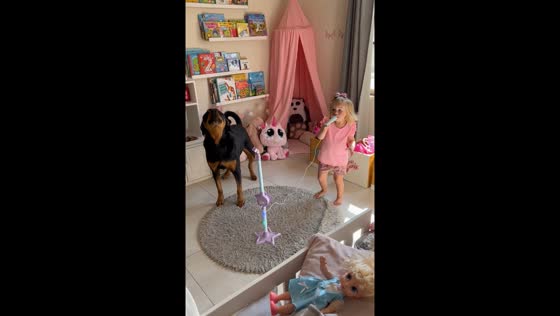 3-Year-old Gia and Rottweiler Zara sing together in Lusaka, Zambia