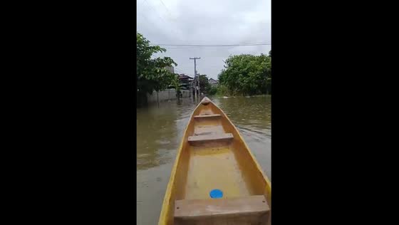 Residents use boats to navigate flooded streets in Calumpit, Bulacan