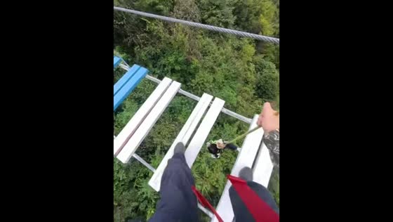 Man pulls his daughter back onto a hanging bridge after she falls in Zhejiang, China