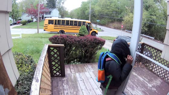 Child rushes for school bus and stumbles at doorway in Warren, Pennsylvania, USA