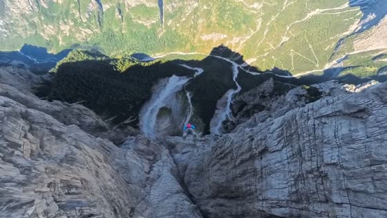 Professional skydiver performs a low-altitude wingsuit flight over mountains in Shandong, China