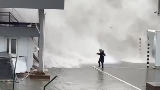 Russian military officer caught by massive sea wave while filming storm