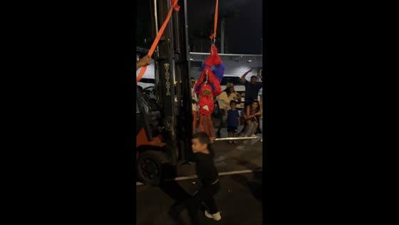 Boy chases piñata holder at birthday party in Puerto Cabello, Venezuela