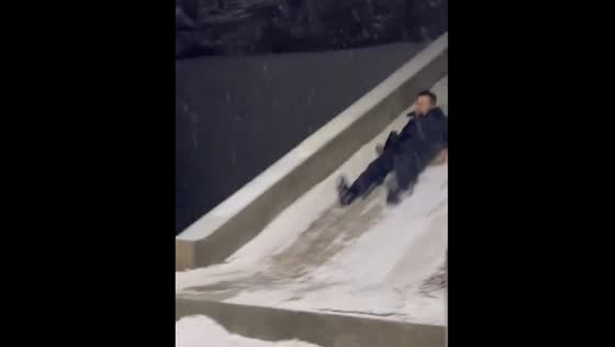 Person slides down snowy ramp in China