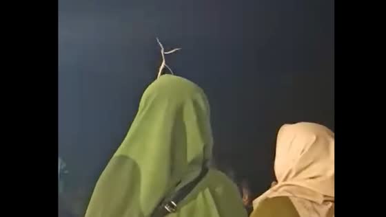 Praying mantis appears to dance on person's head in Gempol, Indonesia