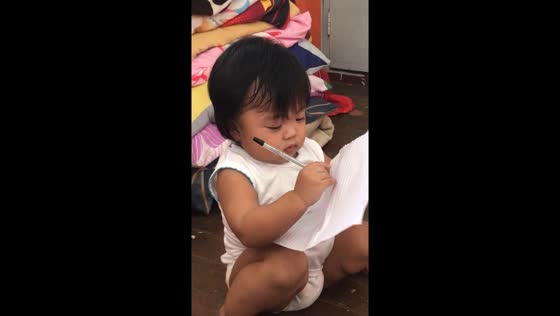1-year-old mimics grade 4 aunt, writing on paper in Baliuag, Bulacan, Philippines