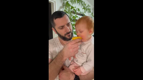 Brave toddler faces the bitter bite of a lemon in Helsinki snack adventure