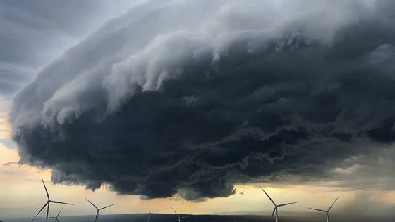 Massive storm cloud looms over wind farm in Beijing, China