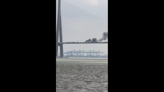 Massive fire sends thick black smoke billowing over bridge in Jiangsu, China