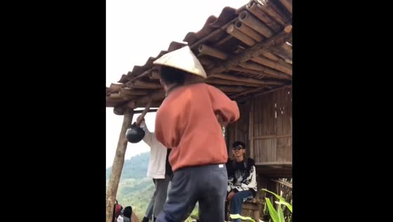 Elderly man bumps head on low roof during hangout in Bandung, Indonesia