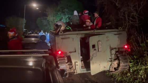 A group of people used tank as sleds and dressed as Santa.