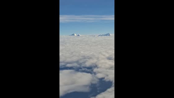 Spectacular Himalayan peaks rise above clouds during flight from Kathmandu, Nepal