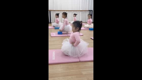 Young student holds posture during ballet training, Guangxi, China