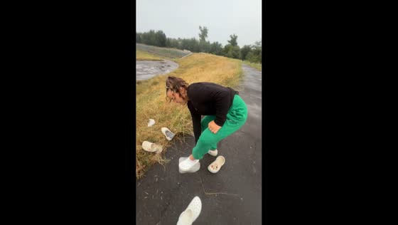 Woman slips while trying to slide down a grassy slope in Kyiv, Ukraine
