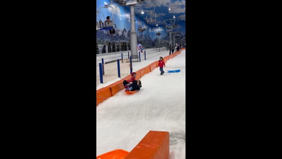 Woman accidentally bumps into child while sledding in South Tangerang, Indonesia