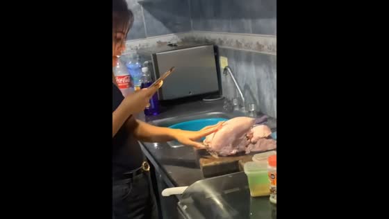 Friend massages meat before cooking in Guayana, Venezuela