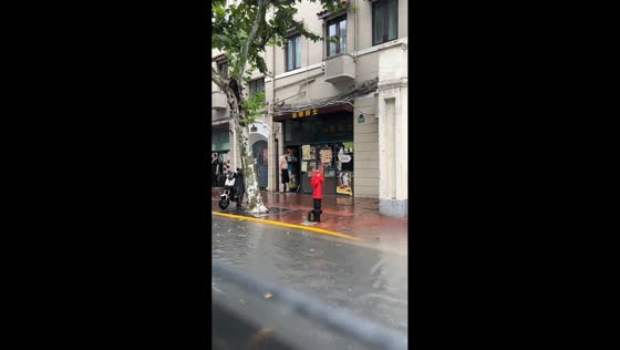 Heavy rain floods streets and shop in Shanghai, China