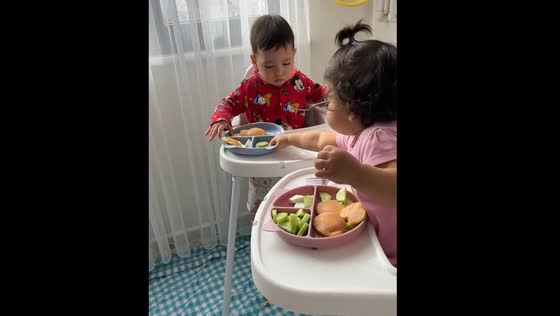 Twin takes sibling's food and adds it to her plate