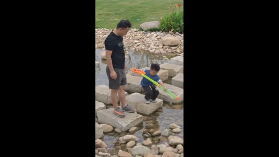 Father accidentally sends son into pond after slipping on stepping stone in Anhui, China