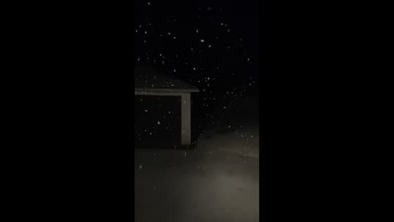 Nighttime snowfall creates snow globe effect in Boston, Massachusetts, USA
