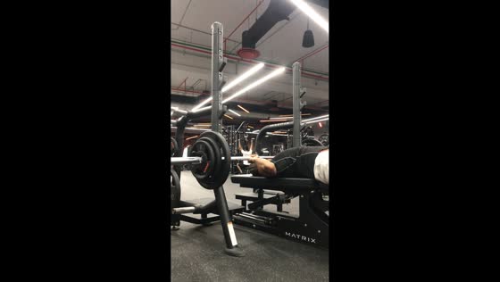 Man struggles with barbell during workout in Dammam, Saudi Arabia