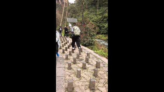 Man hilariously falls off stepping stone path in Hunan, China