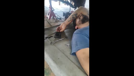 Mechanic pretends to work while sleeping under car in Paraguay