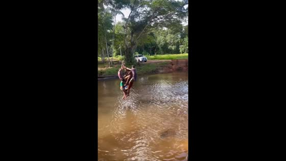 Children enjoy rope swing fun by the river in Mossoró, Brazil