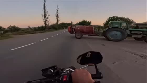 Motorcyclist narrowly avoids collision with tractor in Kharkiv Oblast, Ukraine