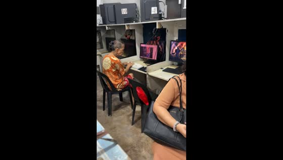 Elderly woman types quickly without looking at keyboard in Ermita, Manila