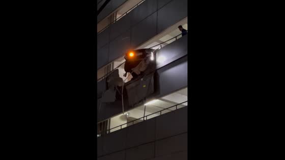 Drunken reversal: car hangs on edge of Makati office building after bizarre accident