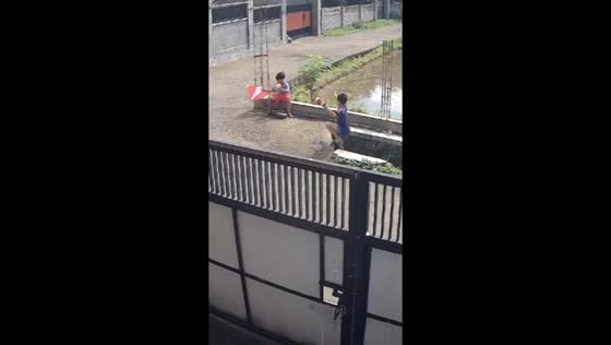 Child falls into ditch while flying kite in Lombok, Indonesia