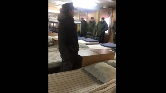 A servicewoman explains the situation with ammunition and medicines to the newly mobilized men