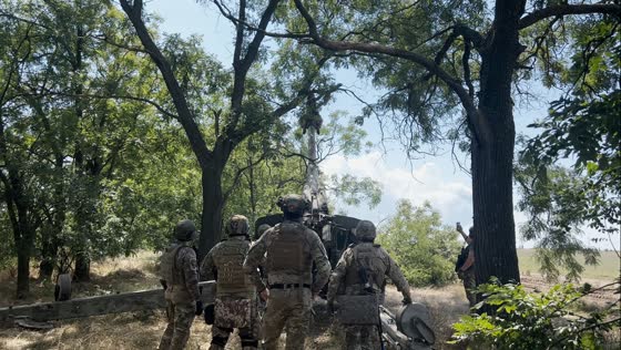 Soldiers utilize artillery vehicle to clear blocked roads by tree cutting