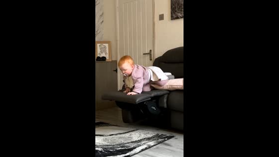 Child tumbles gently from recliner in Lancashire, England, UK