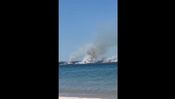 Smoke seen from Sydney Airport as grass fire ignites