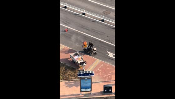 Delivery man’s box catches fire on the road in Tianjin, China
