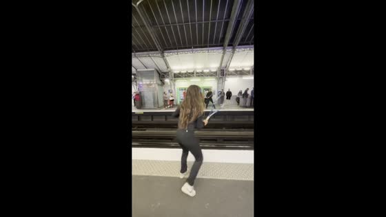 Commuters play casual tennis while waiting for train in Paris, France
