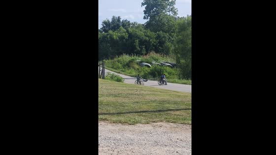 Children ride wheelchairs downhill in Paxton, Indiana