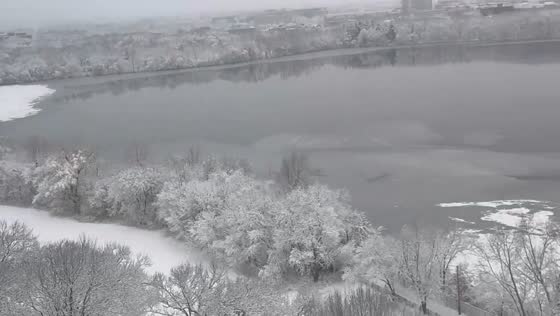 Quiet winter snowfall blankets Fresh Pond in Cambridge, USA