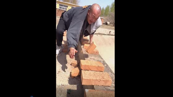 Rural Kung Fu master shatters bricks with bare hands: a display of Chinese martial arts prowess