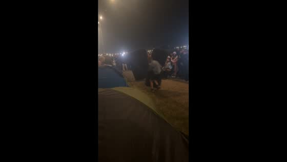 Playful airbed joust duel at Creamfields Festival in England