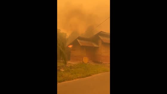 Fire breaks out in vacant lot as thick orange haze blankets Central Kalimantan, Indonesia