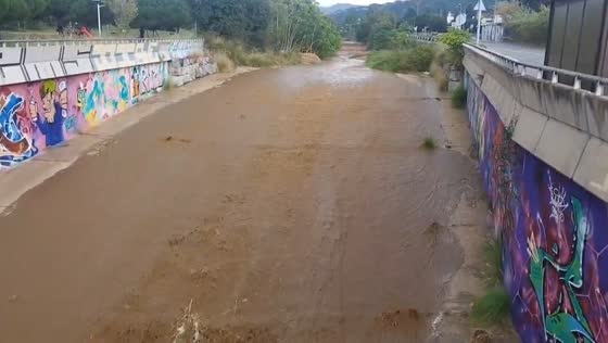 Storm waters rise in drainage canal of Arenys de Mar, Spain