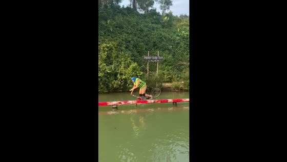 Bicycle mishap: crossing Vietnam's monkey bridge ends in a splash