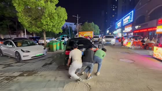 Three men lift parked car to clear path in Anhui, China