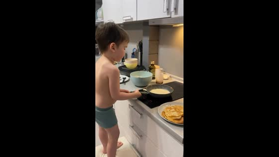 Boy makes pancakes for the first time in Ramenskoye, Moscow, Russia