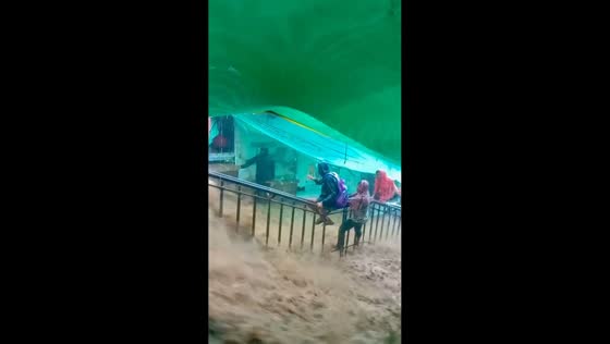 Floodwaters rush down temple stairs in Pavagadh, Gujarat, India