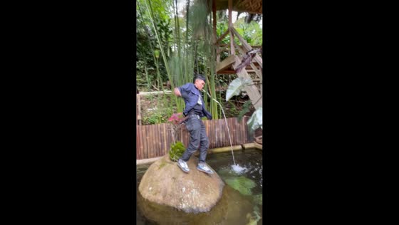 Man slips and falls into pond while posing in Pangalengan, West Java, Indonesia