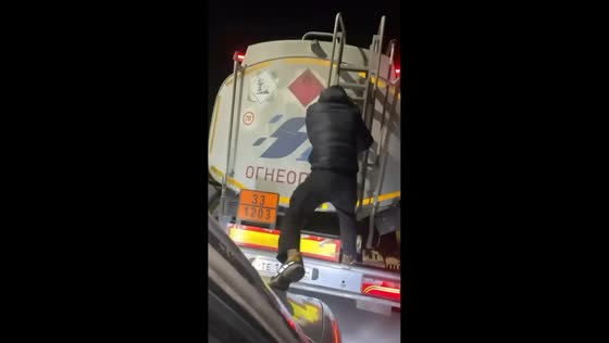 Man jumps from moving car onto fuel truck on highway in Russia